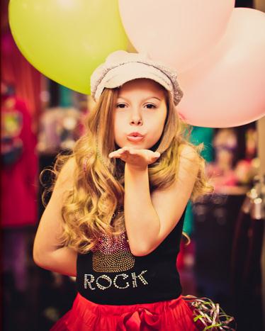 Birthday girl holding baloons